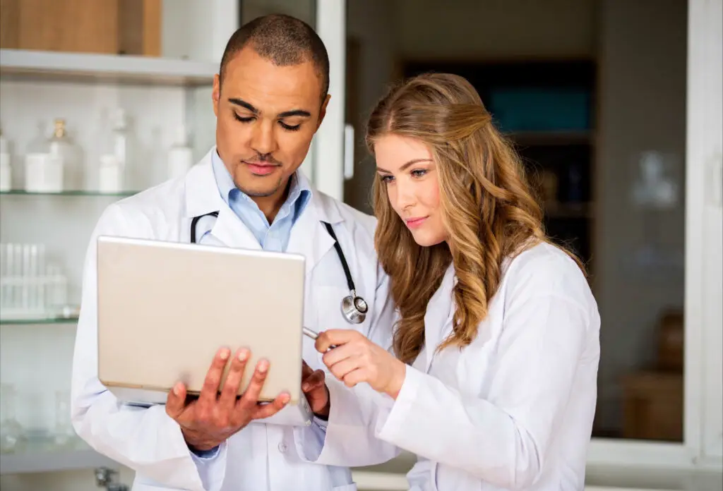 Two doctors collaborating on a tablet in medical office — cloud-based IT solutions and Microsoft 365 support for healthcare practices by Concierge IT in Palm Beach County
